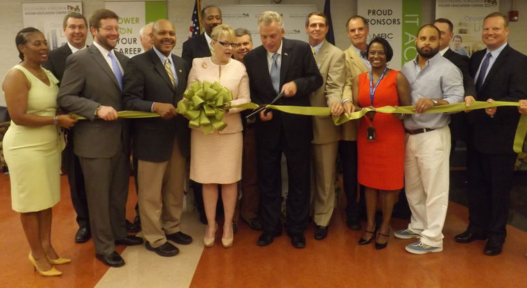 Alongside Southern Virginia Higher Education Center Executive Director Dr. Betty H. Adams and other distinguished guests, Governor Terry McAuliffe cuts the ribbon symbolizing the opening of the higher ed center’s IT Academy. Courses will begin in August.